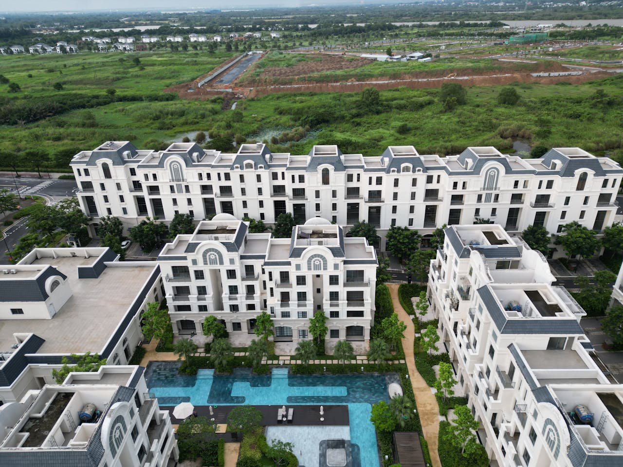 Services Aerial shot of luxury apartment buildings and a pool in Đồng Nai, Vietnam.